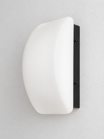Curved white glass and black wall sconce, material detail
