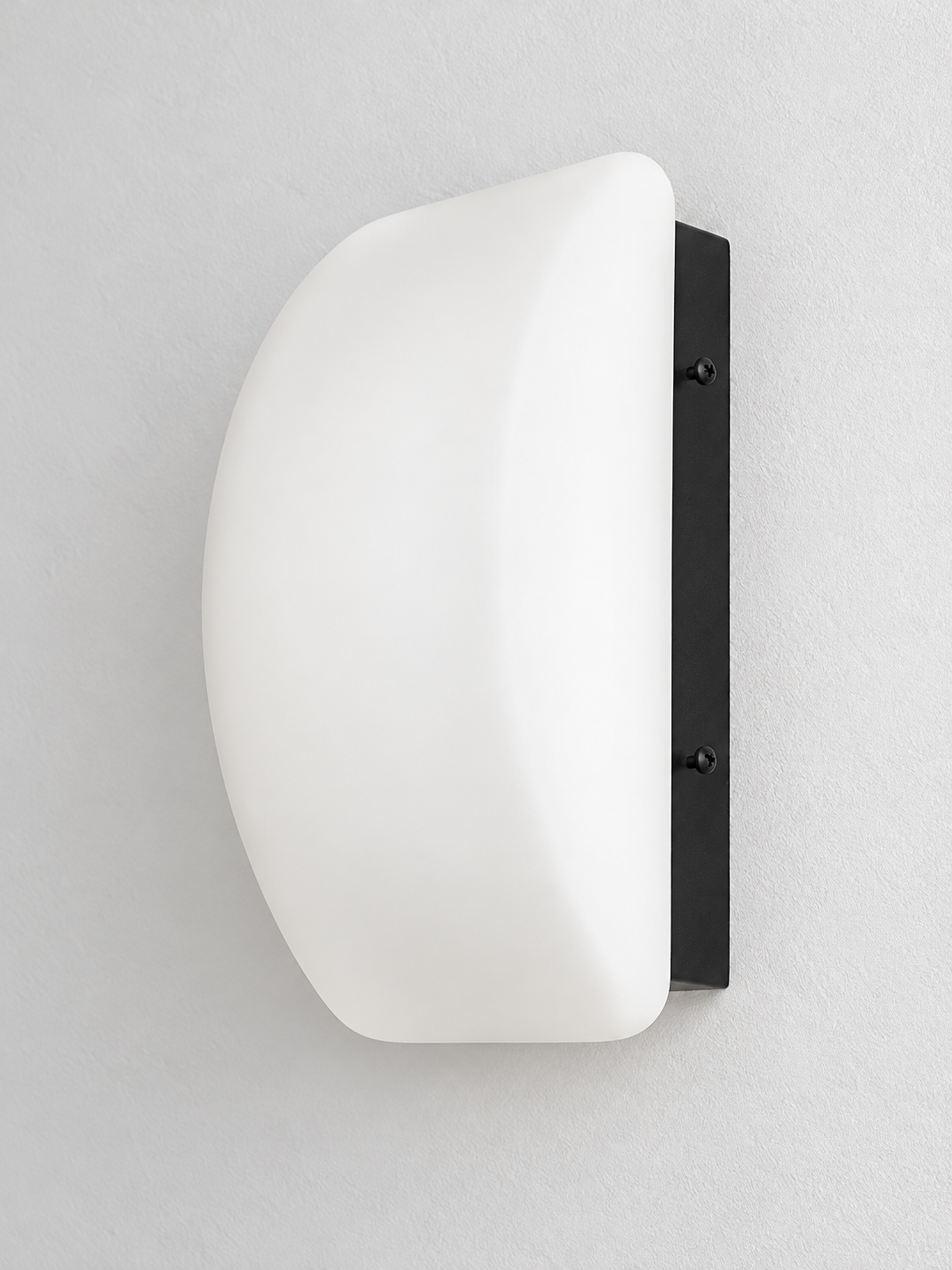Curved white glass and black wall sconce, material detail
