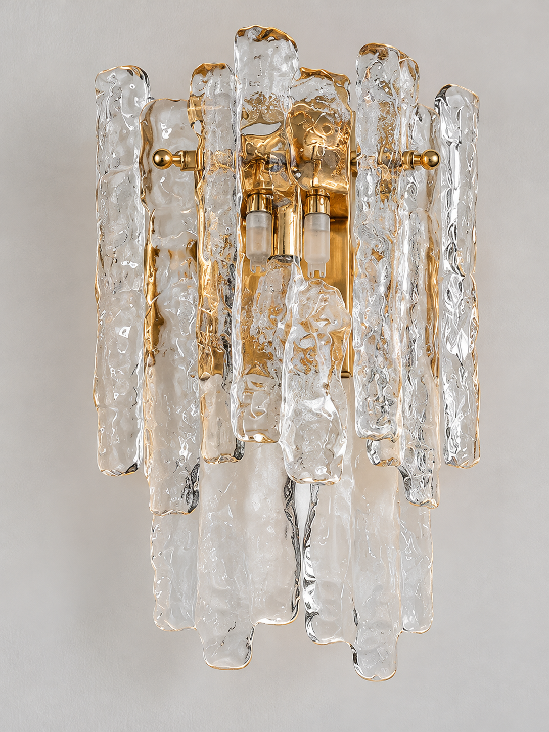 Clear textured ice glass wall sconce with copper-tone frame, glass detail