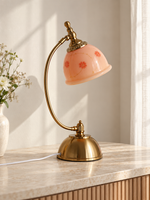 Alternate view of the Blush Bloom Arc table lamp with curved frame and domed copper-tone base