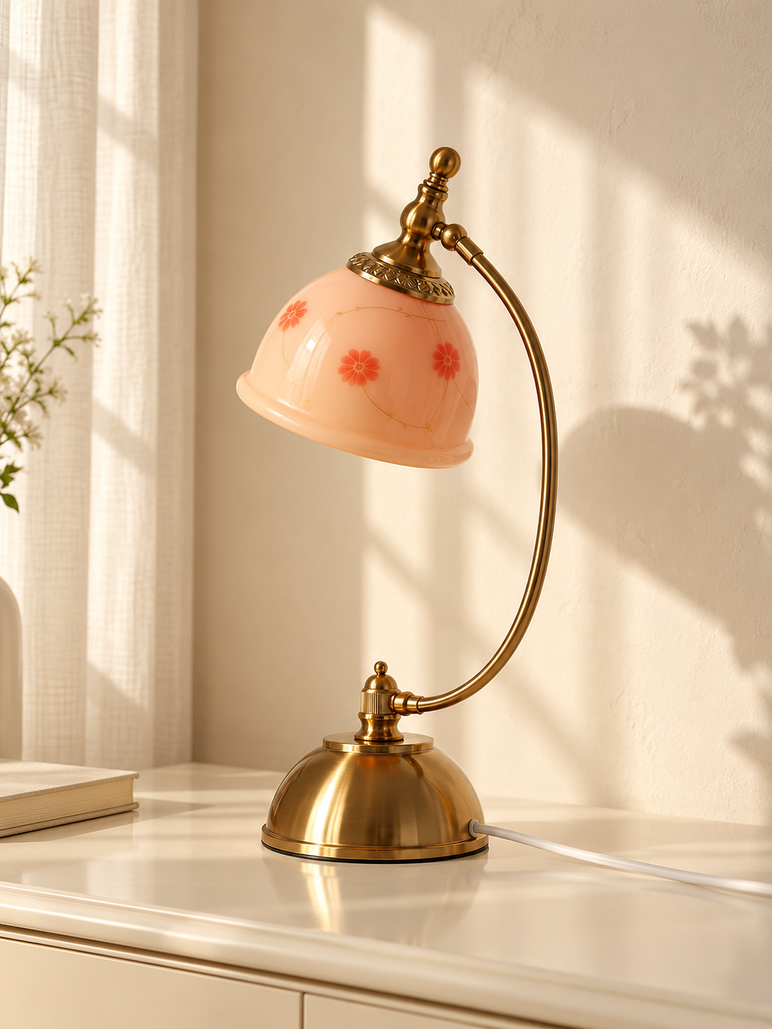 Blush Bloom Arc 220V table lamp with pink floral glass shade and copper-tone curved frame, switched off