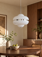 Cloud Saucer glass pendant in chrome and white, unlit above a walnut dining table