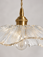 Close-up of the Clear Flower Glass Pendant Light radial glass texture and copper-colored socket