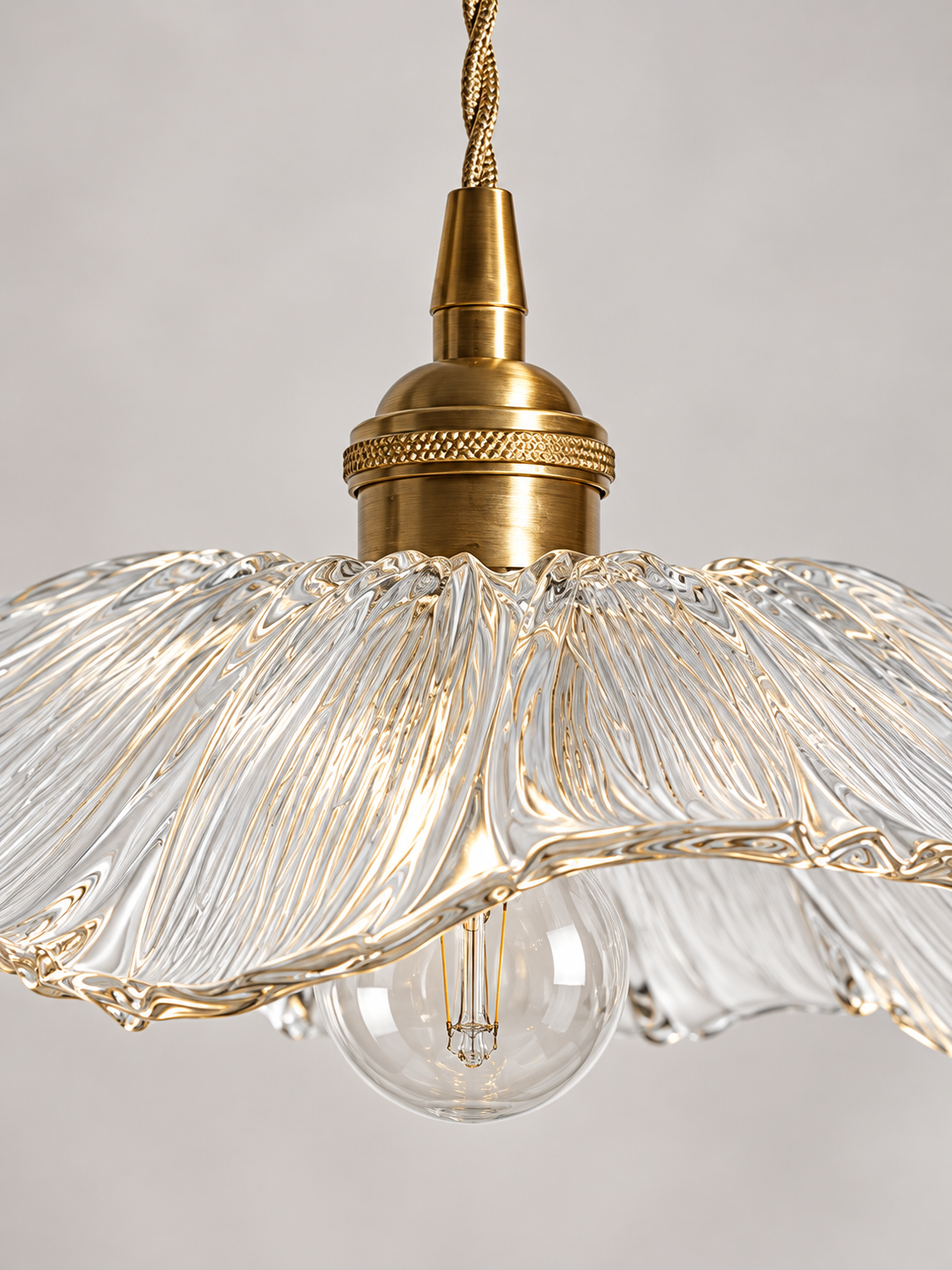 Close-up of the Clear Flower Glass Pendant Light radial glass texture and copper-colored socket