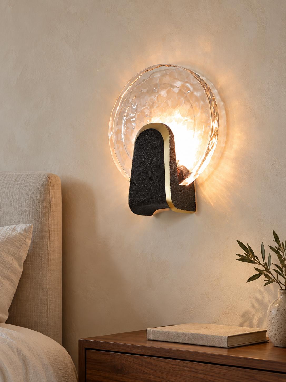 Halo Crest round clear textured glass LED wall light with black copper-edged crest in a bedroom