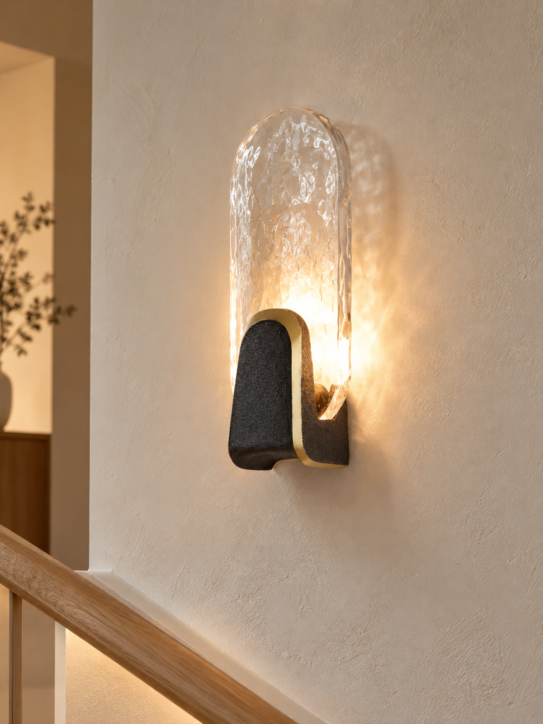 Halo Crest oval clear textured glass LED wall light on a stair landing