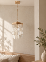 Ivory Shell Cascade Pendant unlit in a warm natural-light interior
