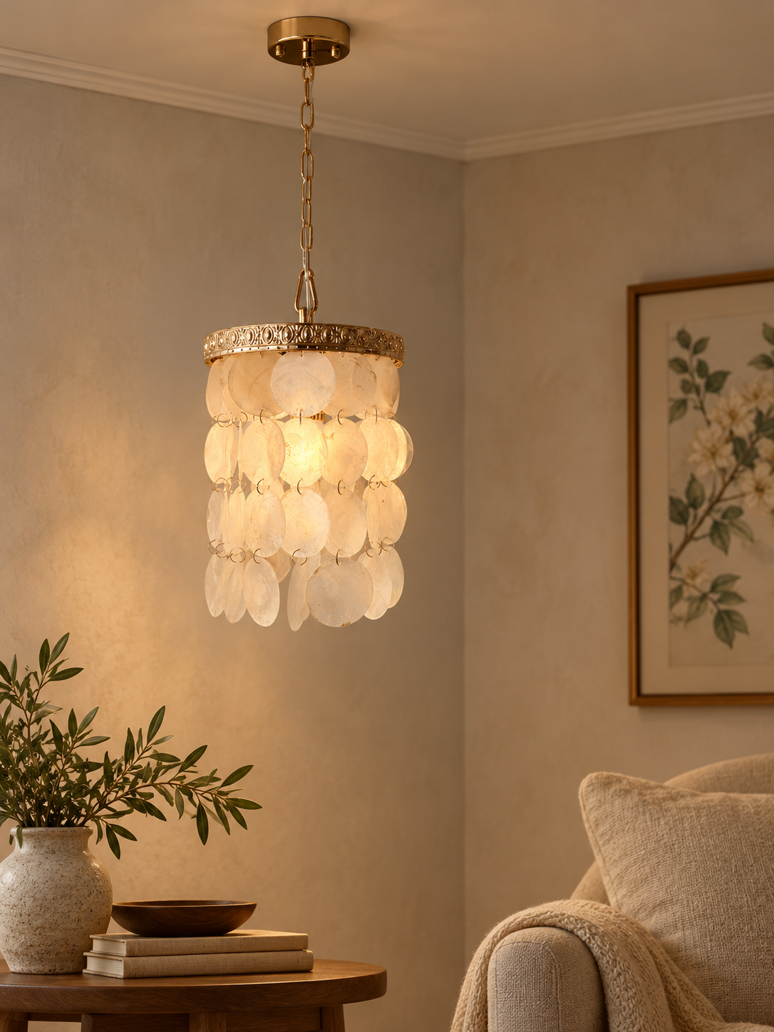 Ivory Shell Cascade Pendant illuminated in a warm reading corner