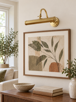 Copper-tone picture light above artwork, unlit