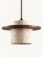 Travertine and wood pendant, dark walnut tone, single stone-cylinder shade with a flat wood disc and cord, fixture switched off