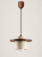 Travertine and wood pendant, dark walnut tone, single stone-cylinder shade with a flat wood disc, adjustable-lift ceiling housing and projecting white bulb, fixture switched off