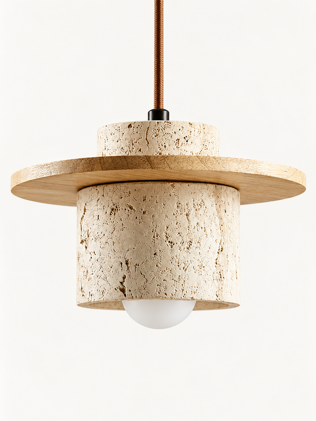 Travertine and wood pendant, natural wood tone, single stone-cylinder shade with a flat wood disc, cord and projecting white bulb, fixture switched off