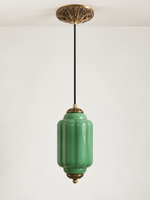 Green ribbed glass pendant with copper-tone hardware and embossed canopy, shown switched off in daylight