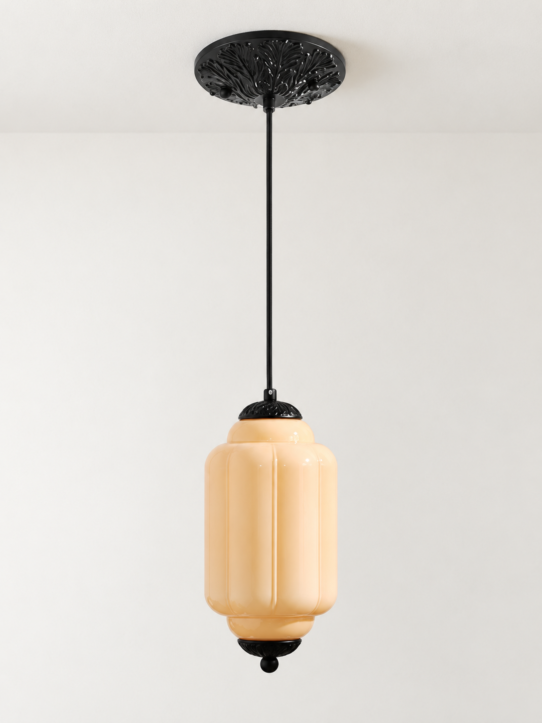 Melon ribbed glass pendant with black hardware and embossed canopy, shown switched off in daylight
