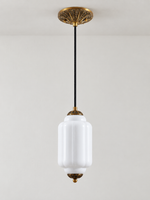 White ribbed glass pendant with copper-tone hardware and embossed canopy, shown switched off in daylight