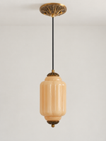 Melon ribbed glass pendant with copper-tone hardware and embossed canopy, shown switched off in daylight