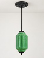 Green ribbed glass pendant with black hardware and embossed canopy, shown switched off in daylight