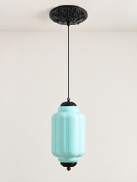 Blue ribbed glass pendant with black hardware and embossed canopy, shown switched off in daylight