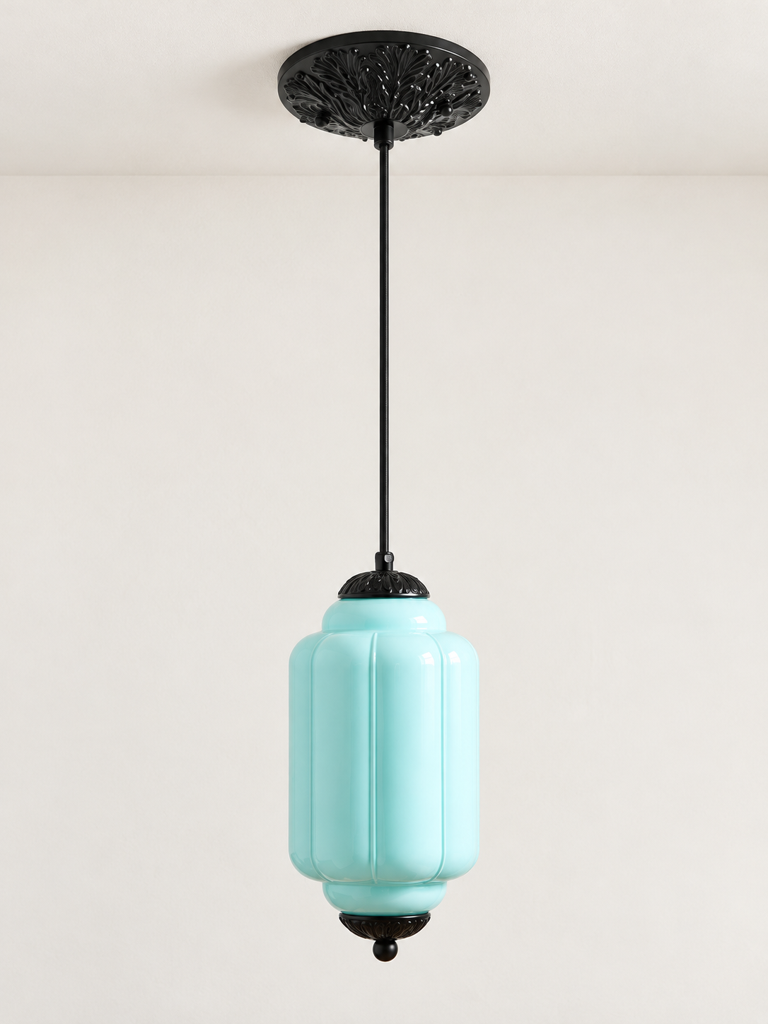 Blue ribbed glass pendant with black hardware and embossed canopy, shown switched off in daylight
