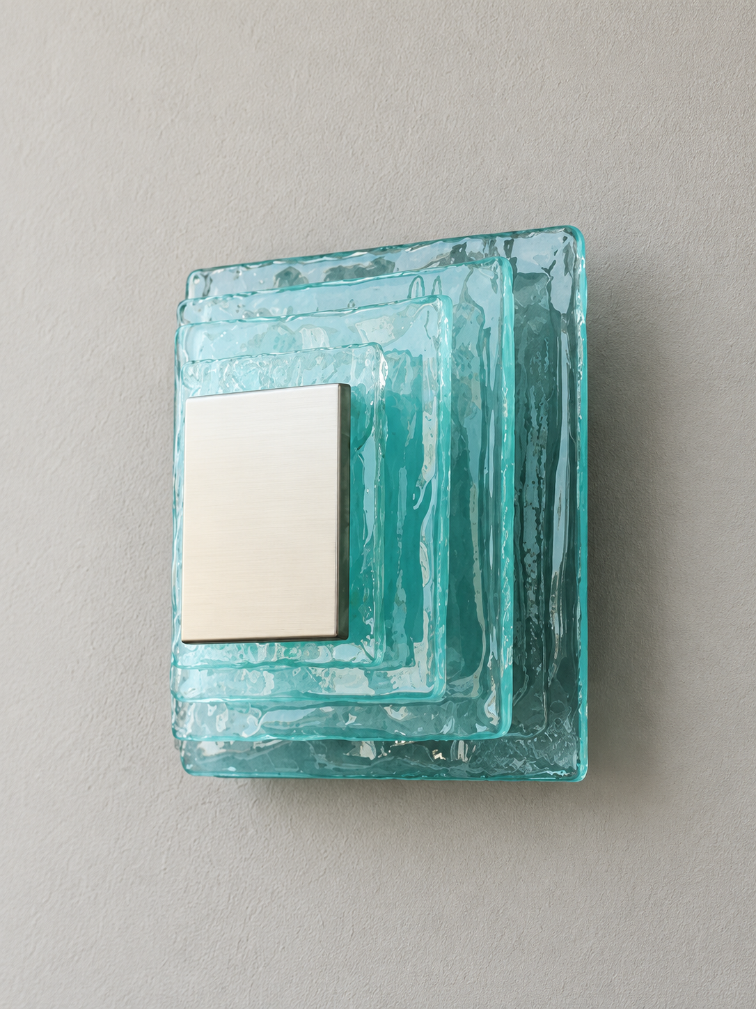 Small wall sconce with blue textured glass and white acrylic insert behind a brushed-metal cover, shown switched off in daylight