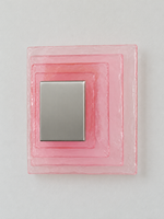 Small wall sconce with pink textured glass and yellow acrylic insert behind a brushed-metal cover, shown switched off in daylight