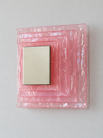 Large wall sconce with pink textured glass and yellow acrylic insert behind a brushed-metal cover, shown switched off in daylight