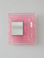 Small wall sconce with pink textured glass and white acrylic insert behind a brushed-metal cover, shown switched off in daylight