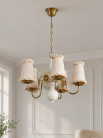 Copper-tone and white 5-light chandelier with cream pleated fabric shades and ruffled trim, shown switched off