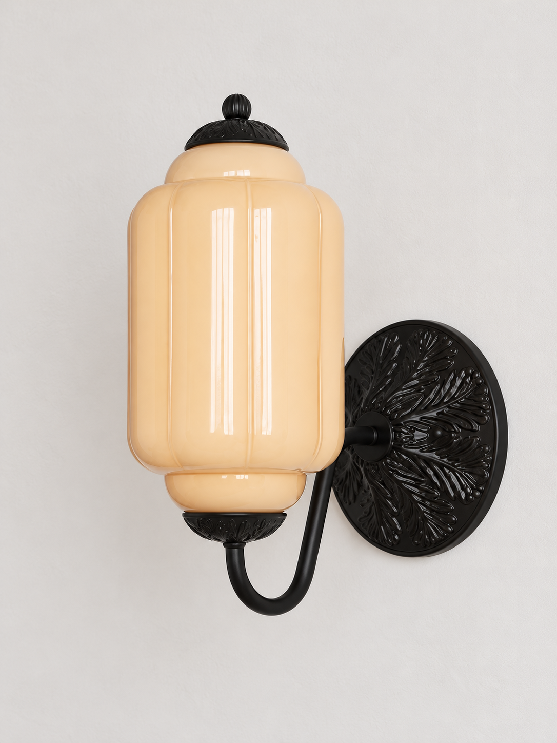 Melon ribbed glass wall sconce with black U-arm and ornate round medallion backplate, shown switched off