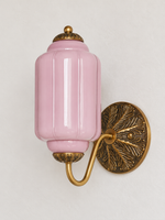 Purple ribbed glass wall sconce with copper-tone U-arm and ornate round medallion backplate, shown switched off