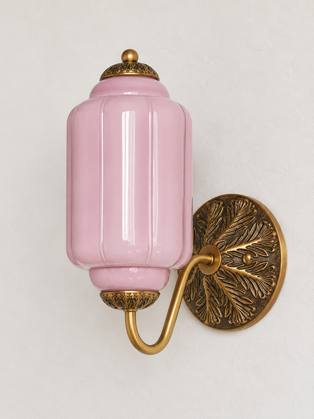 Purple ribbed glass wall sconce with copper-tone U-arm and ornate round medallion backplate, shown switched off