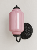 Purple ribbed glass wall sconce with black U-arm and ornate round medallion backplate, shown switched off