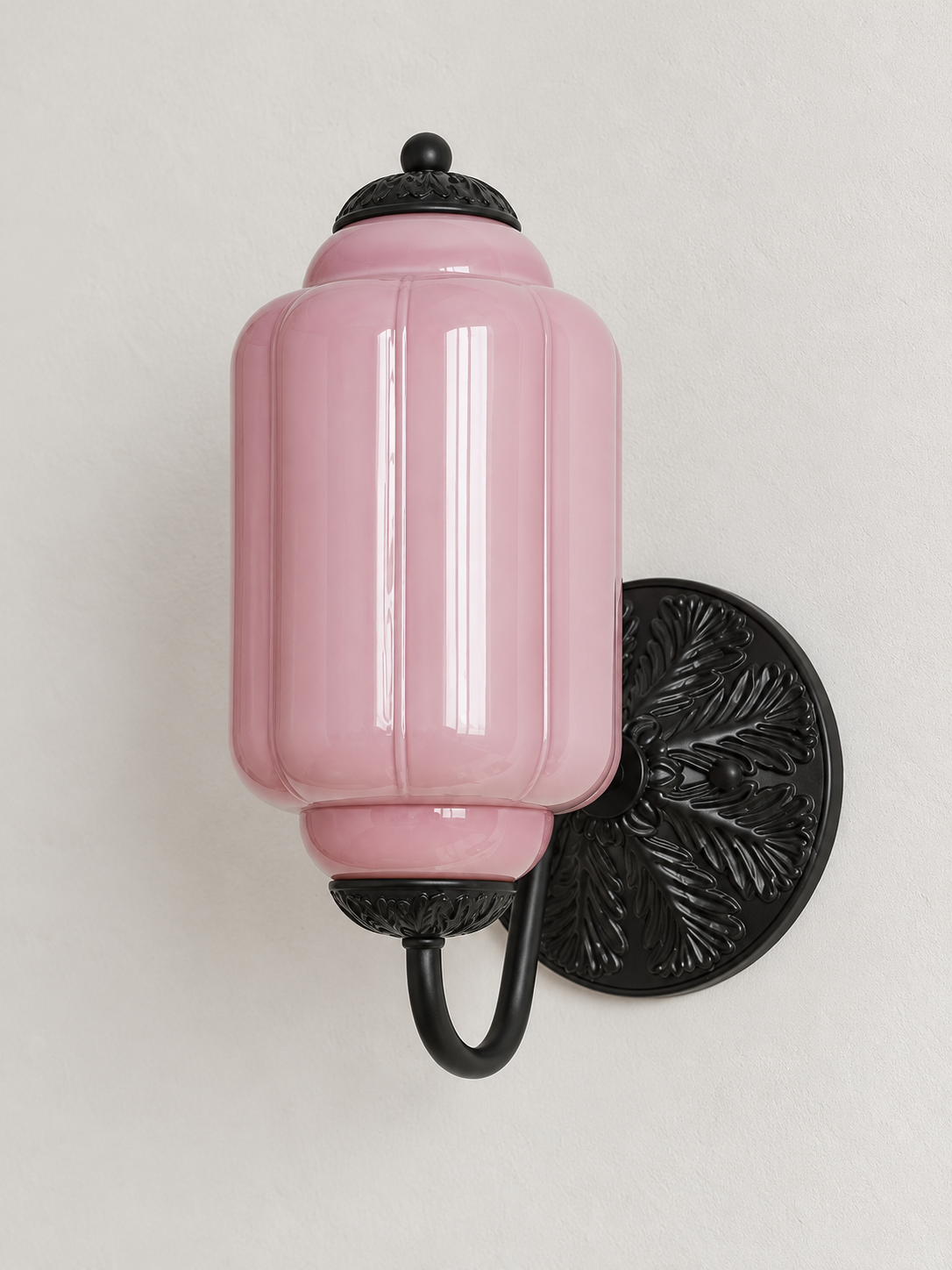 Purple ribbed glass wall sconce with black U-arm and ornate round medallion backplate, shown switched off