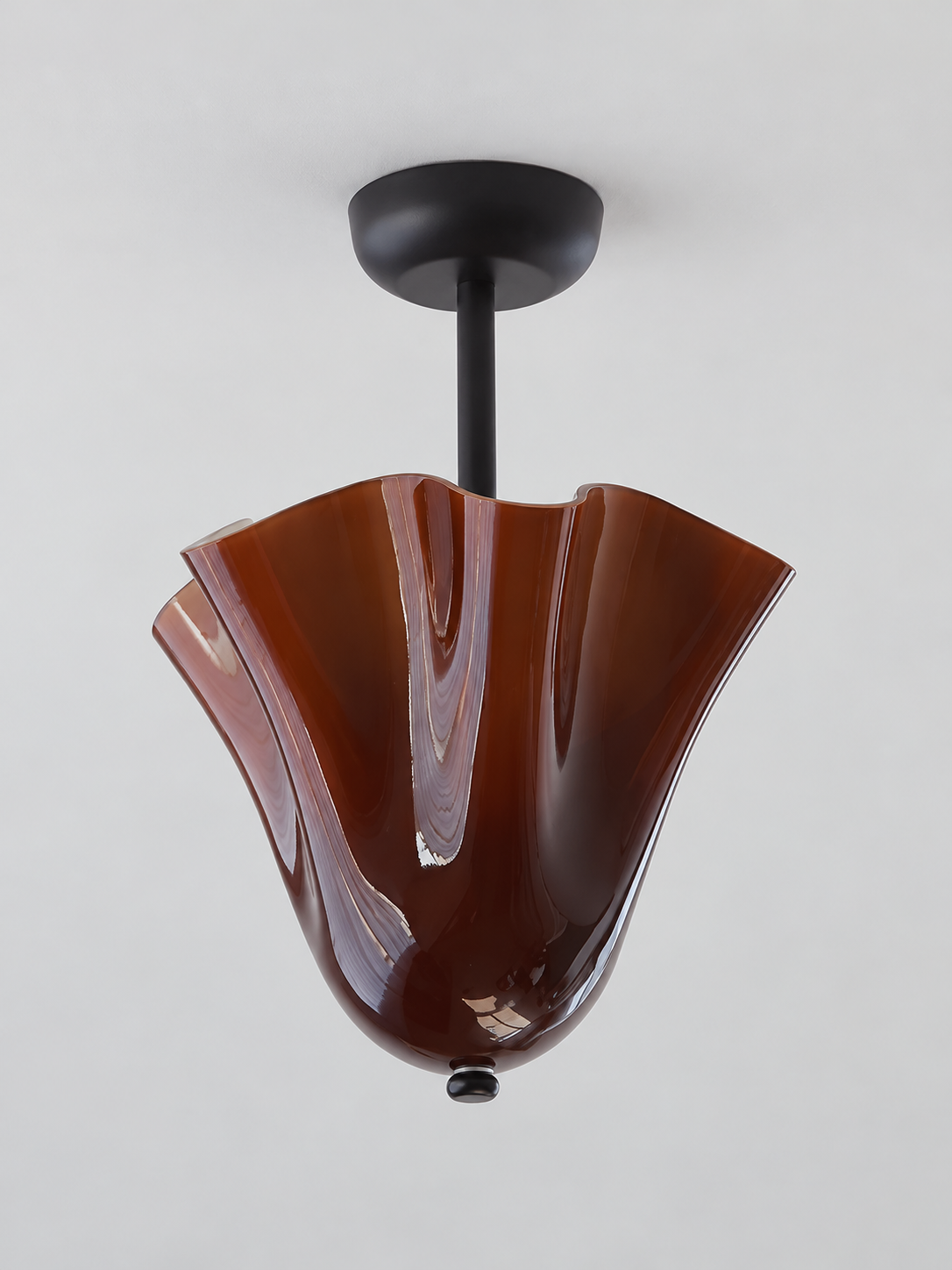 Amber gathered glass semi-flush ceiling light with black canopy and short stem, shown switched off without bead studs