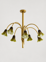 Green 7-light flower glass chandelier with copper-tone arched arms, shown switched off.