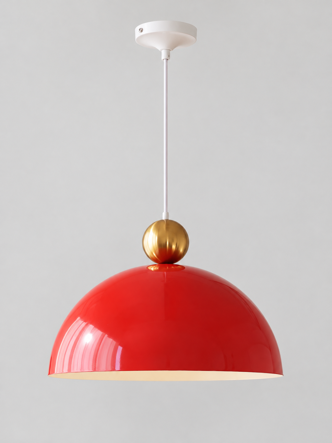 Pomegranate Red 40 cm metal dome pendant with a gold-tone orb, white cord and canopy, shown switched off