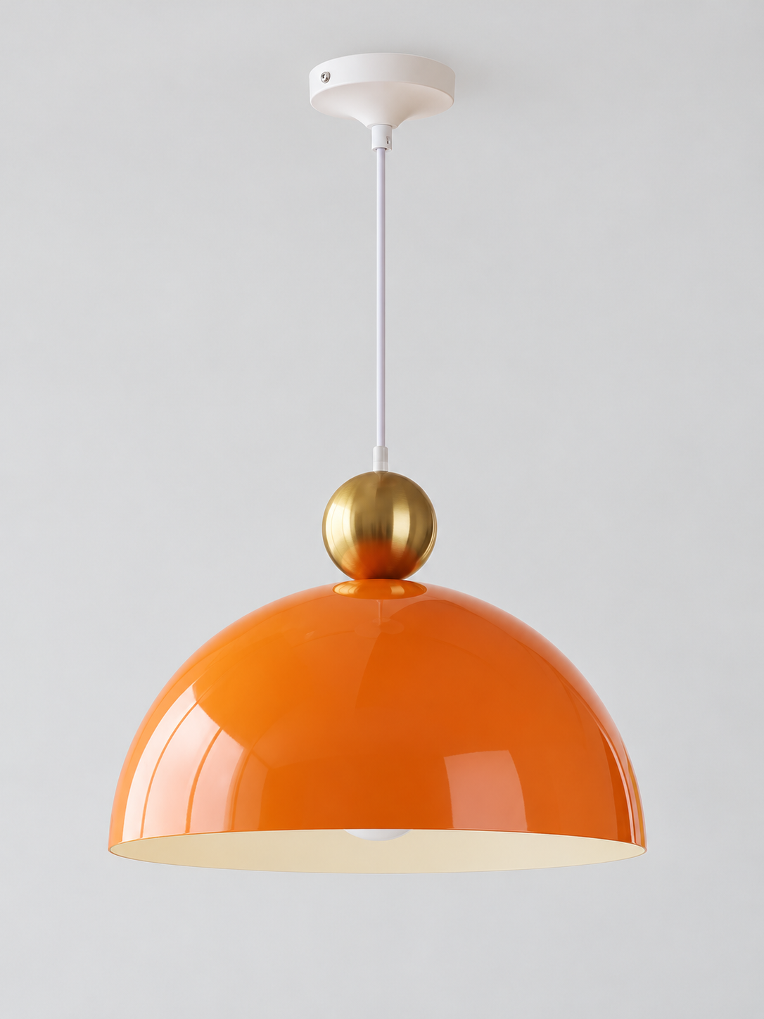 Orange 40 cm metal dome pendant with a gold-tone orb, white cord and canopy, shown switched off