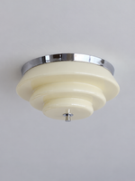 Chrome and cream stepped glass ceiling light, switched off against a neutral ceiling