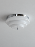 Chrome and white stepped glass ceiling light, switched off against a neutral ceiling