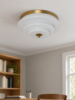 Bronze-tone and white stepped glass ceiling light, switched off in a daylight study