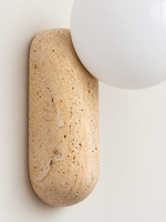Travertine pill wall light with opal glass globe — material detail v1
