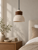 Travertine dome pendant with stacked wood rings — bedside scene v1
