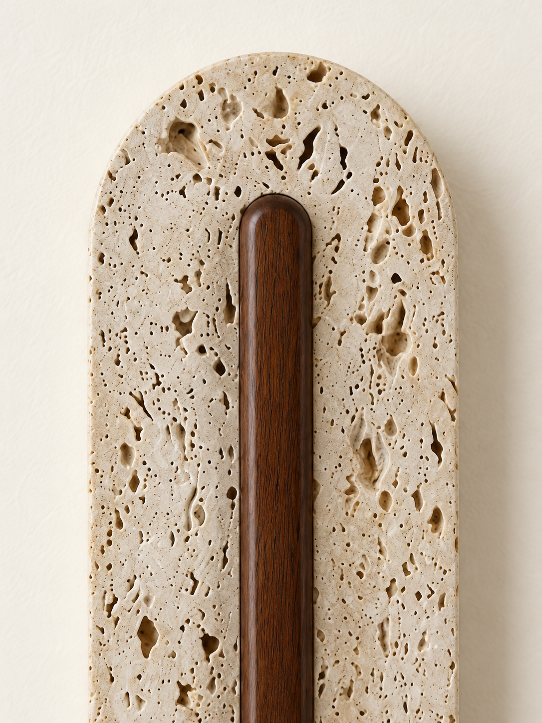 Perforated travertine LED wall light with central wood — detail