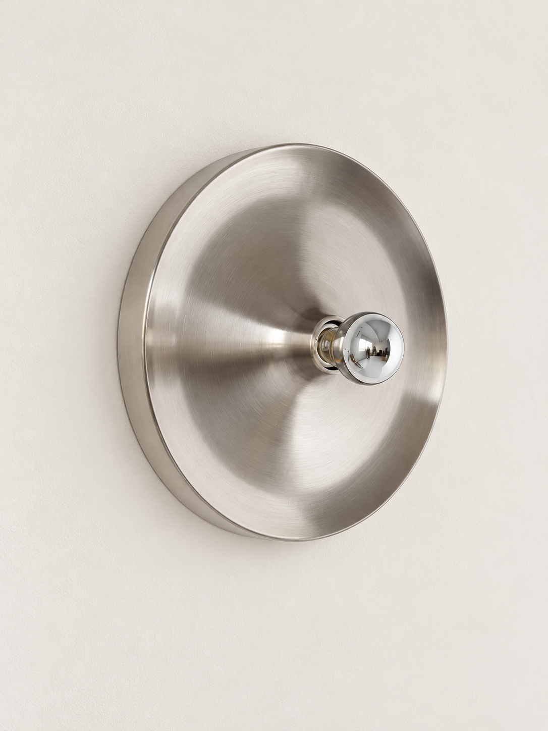Brushed silver smooth reflector wall light with mirror-top bulb, unlit