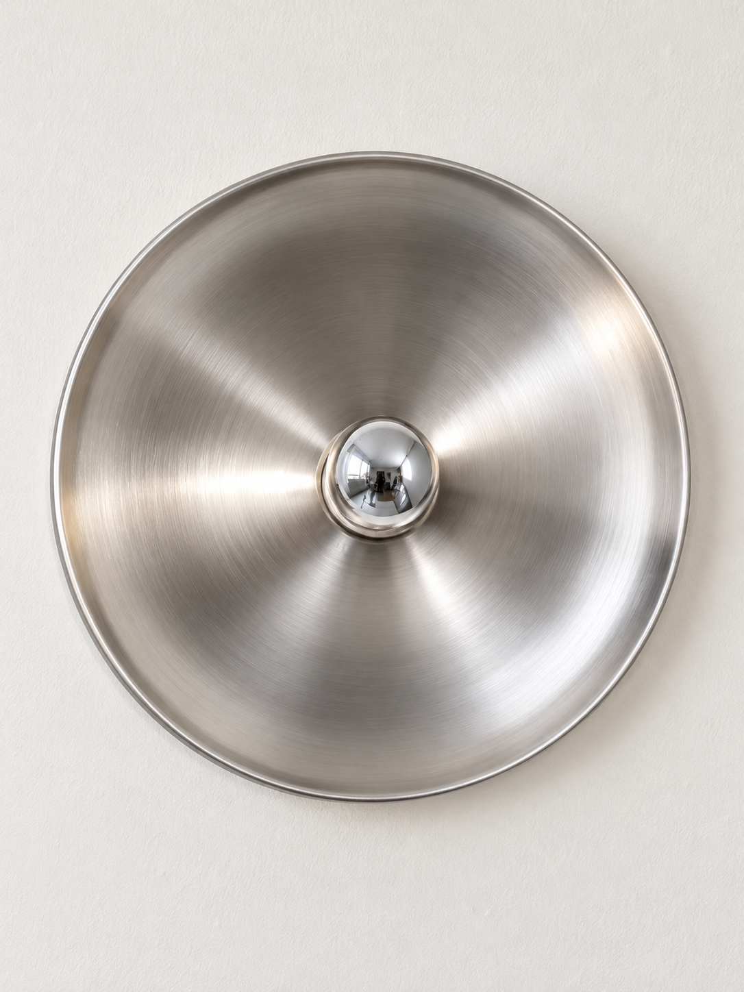 Front view of brushed silver reflector wall light