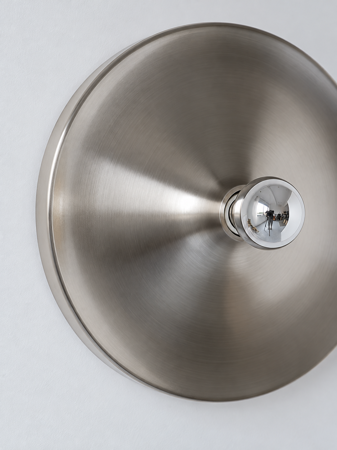 Brushed iron reflector and mirror-top bulb detail