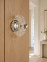 Clear ripple glass wall sconce in a hallway