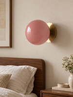 Scalloped-Mount Glass Globe Wall Sconce — Copper-Tone / Pink — unlit interior scene