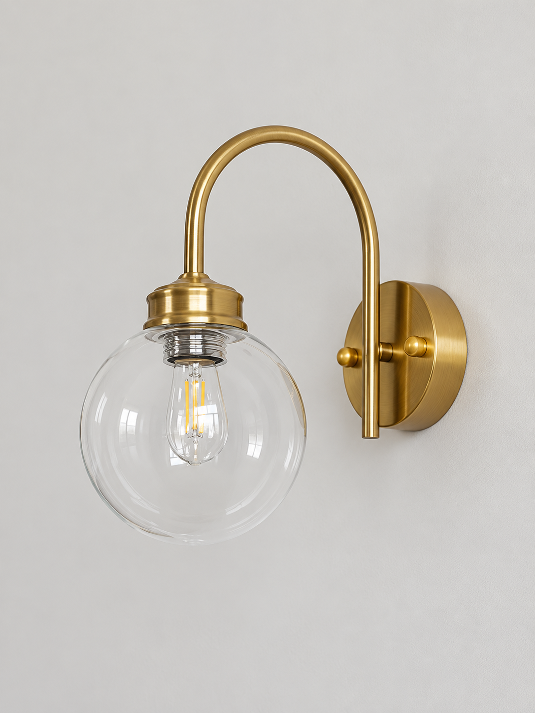 Curved-Arm Glass Globe Wall Sconce, 220–240V — Copper-Tone / Clear — unlit product view
