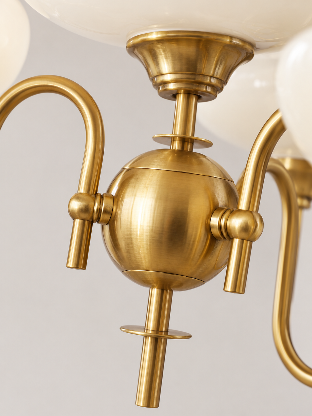 Looped metal arm and glass shade detail